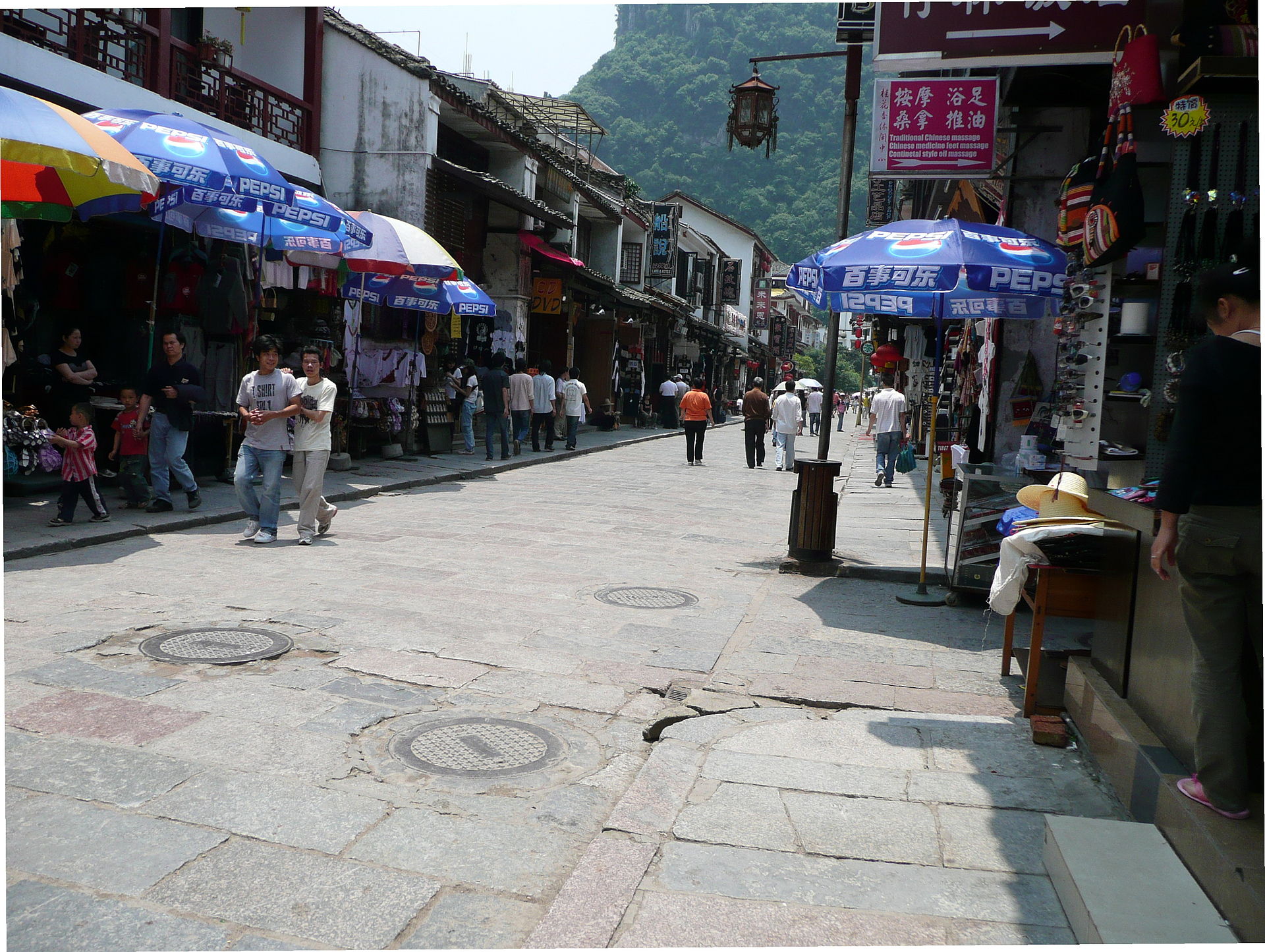 ถนนซีเจียหยางซั่วยามค่ำ ถนนคนเดินมีร้านอาหารและไฟเปิด ภาพแทนมื้อค่ำปลาแช่เบียร์ริมแม่น้ำ