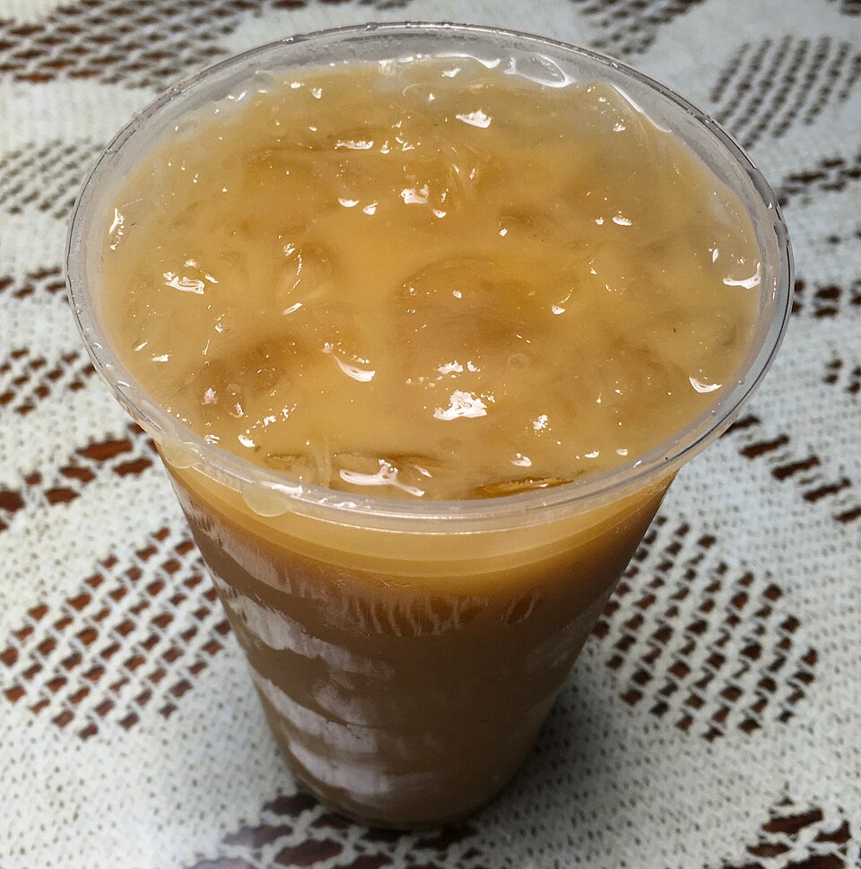 Tejuino fermented corn drink in a cup with lime and salt
