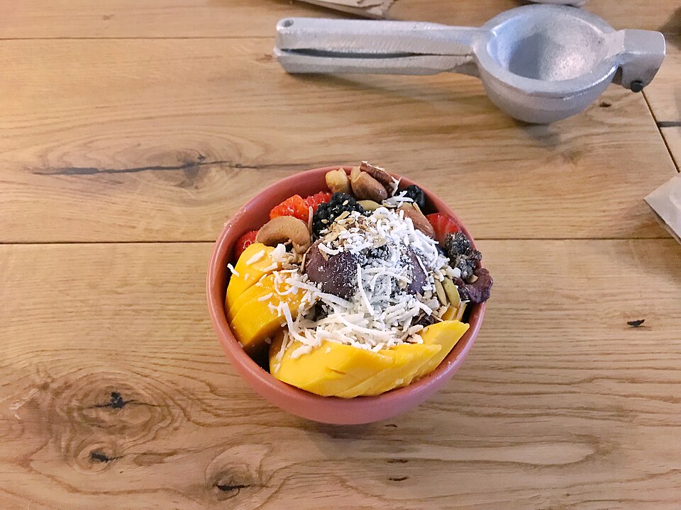 Açaí bowl, a purple fruit bowl topped with granola, banana, and fresh fruit