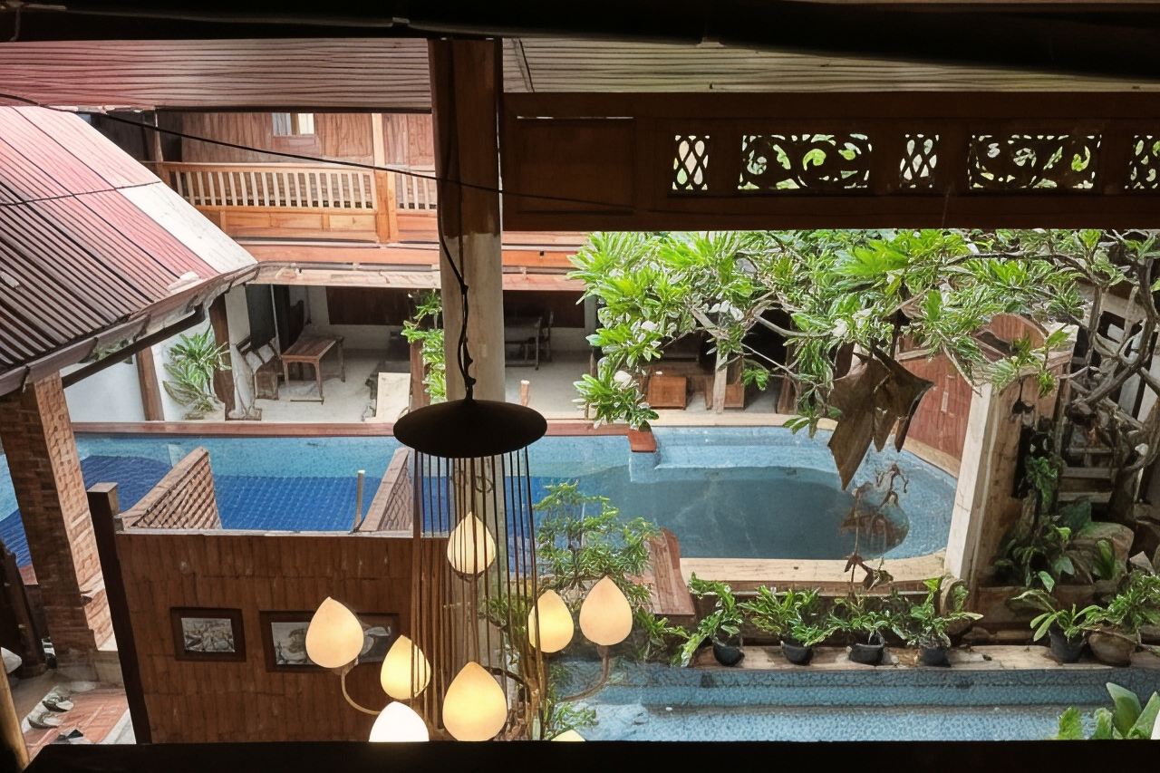 Courtyard swimming pool surrounded by teak buildings at Tony's Place Ayutthaya