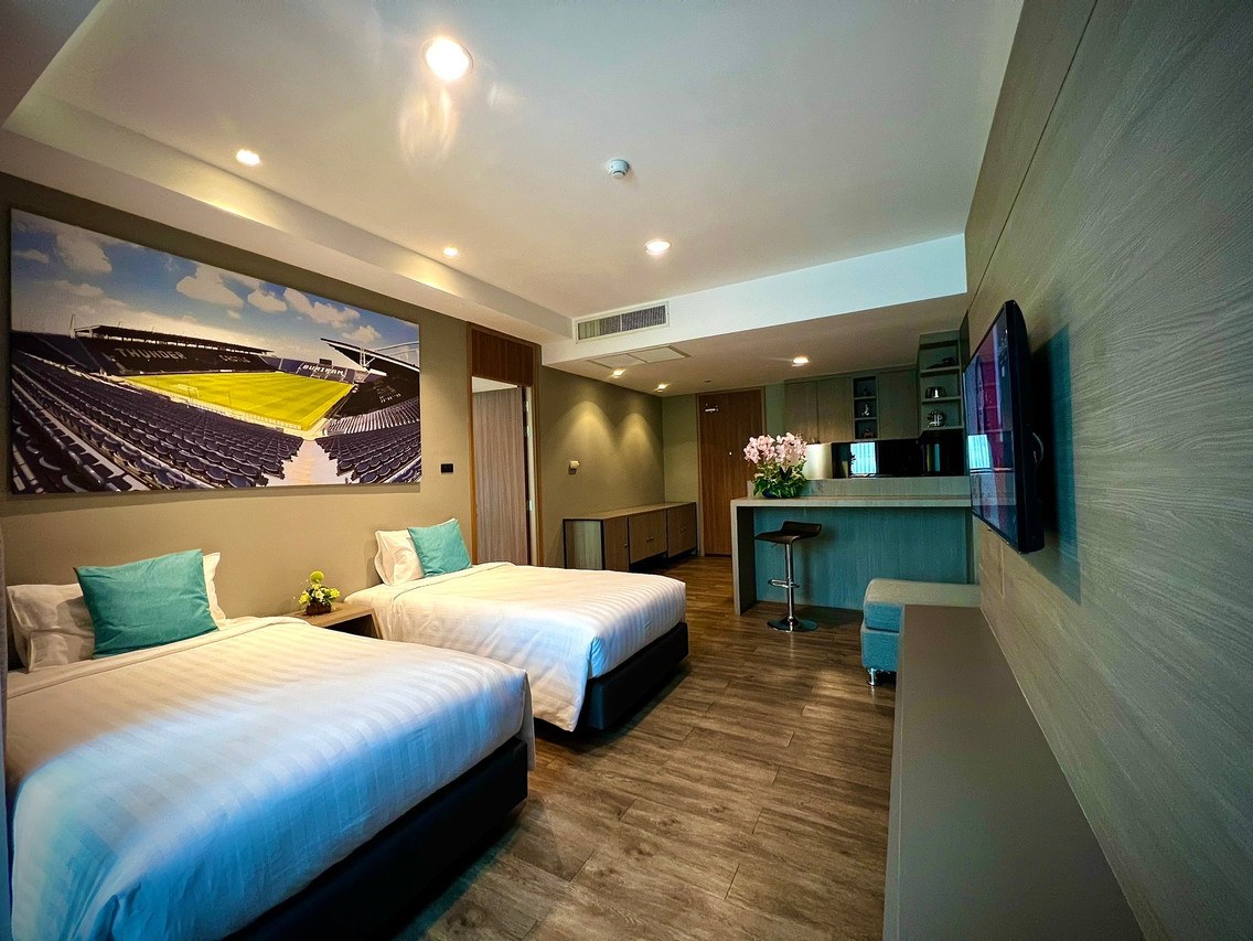ห้องพัก Deluxe Twin มีรูปสนาม Chang Arena เหนือหัวเตียง