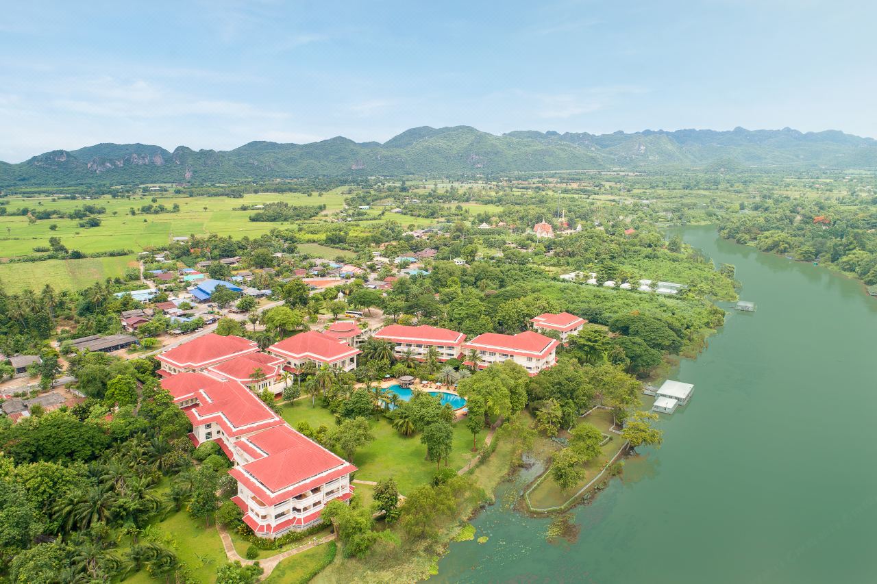 Aerial view of Dheva Mantra Resort beside the River Kwai and the Kanchanaburi hills