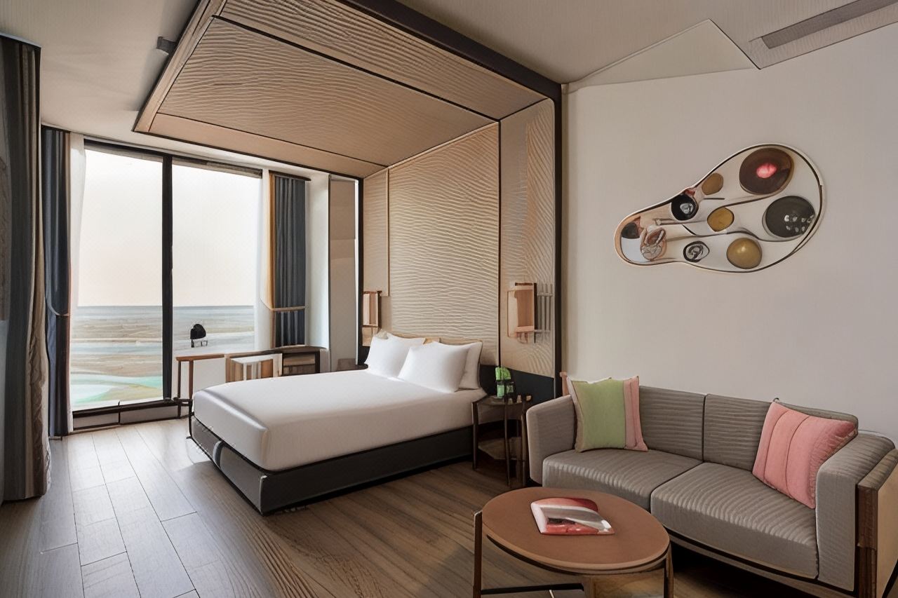 Ad Lib Khon Kaen guest room with king-size bed, textured surround and floor-to-ceiling city views