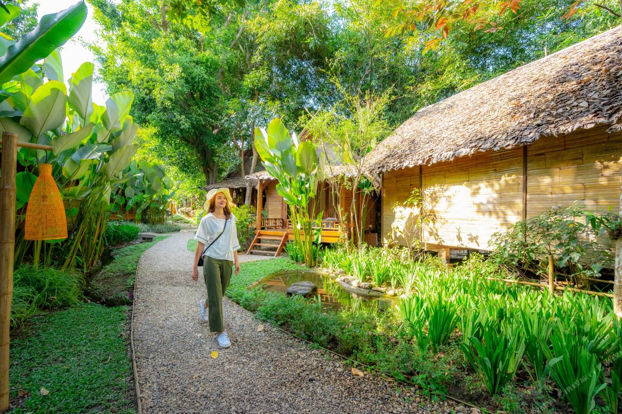 ทางเดินในสวนผ่านกระท่อมไม้ไผ่หลังคามุงจาก Pai Village