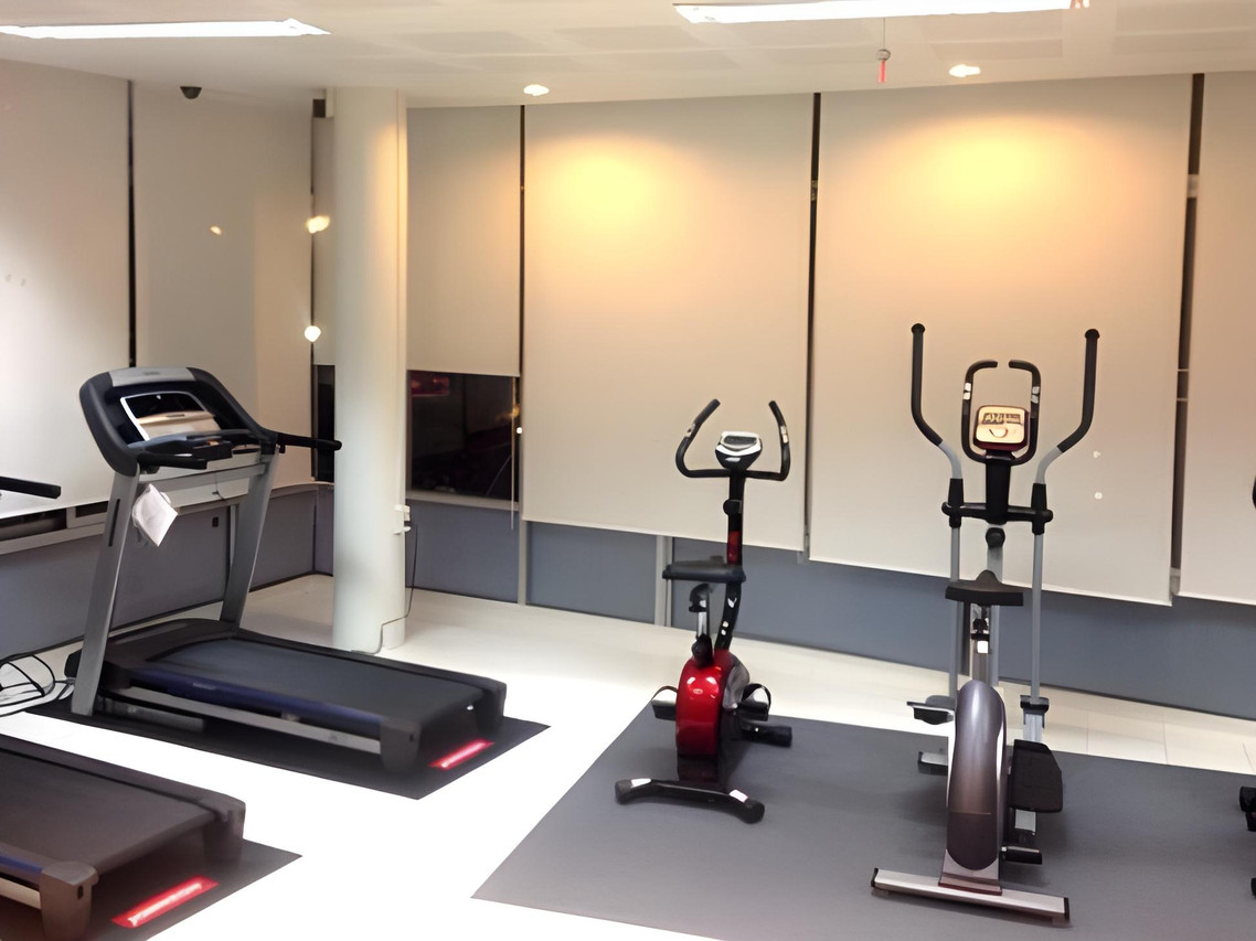 Fitness room with a treadmill and exercise bikes
