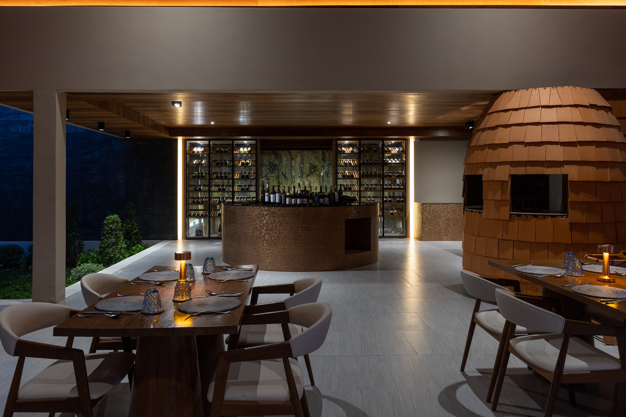 Restaurant interior at Irene Pool Villa Resort with a copper-tiled bar and a wine wall