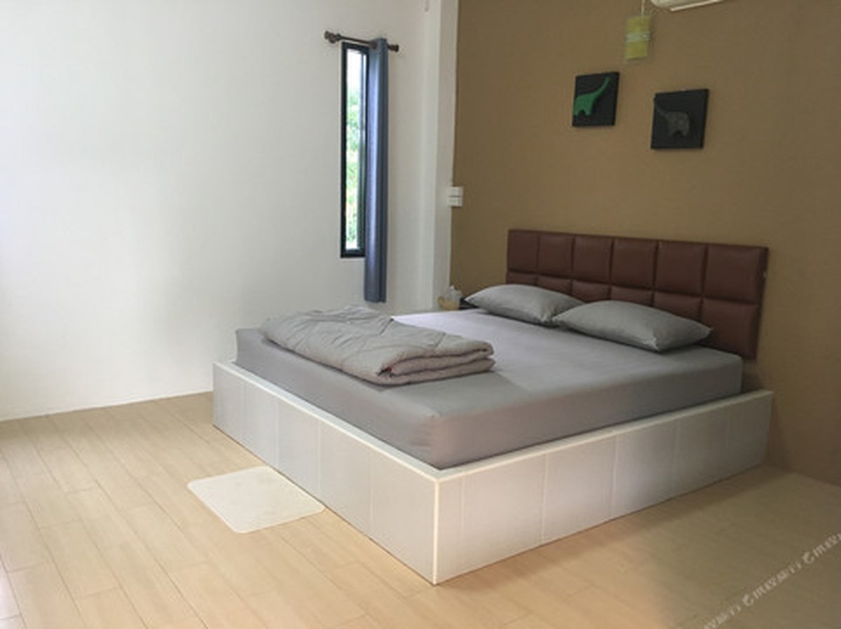 Superior Double room with a platform bed and warm wall tones