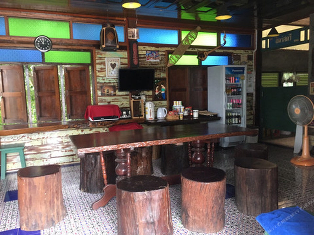 Wooden common area with a slab table and a drinks fridge