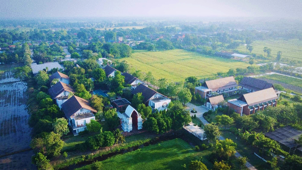 Aerial view of Sukhothai Treasure Resort among the rice fields on the Old City side