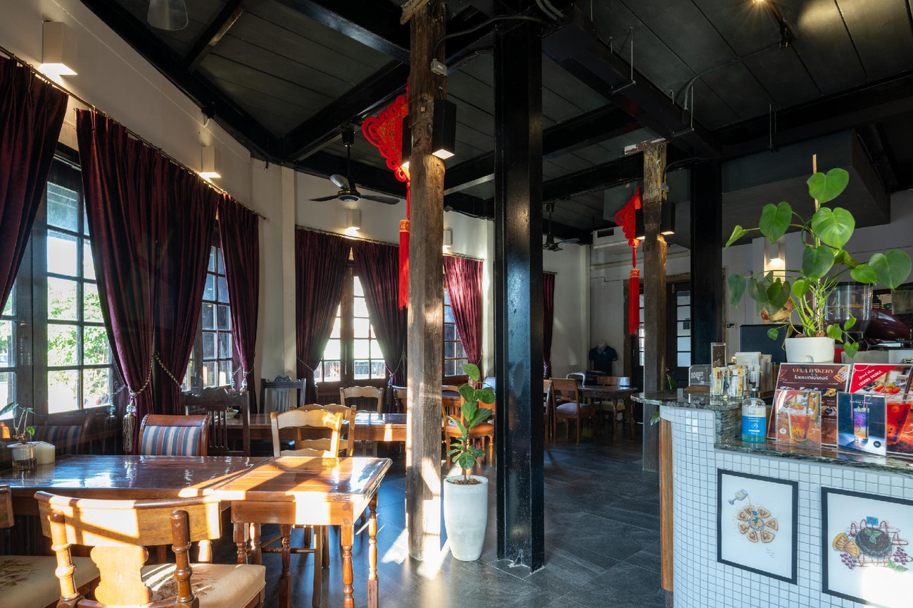 VELABAR restaurant and cafe with old wooden tables and deep-red curtains